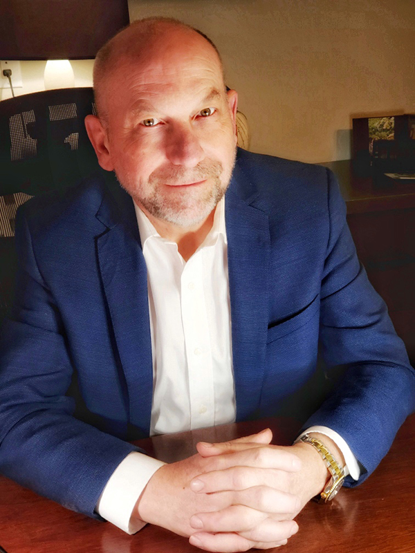 Stephen Funtig sitting at his desk.